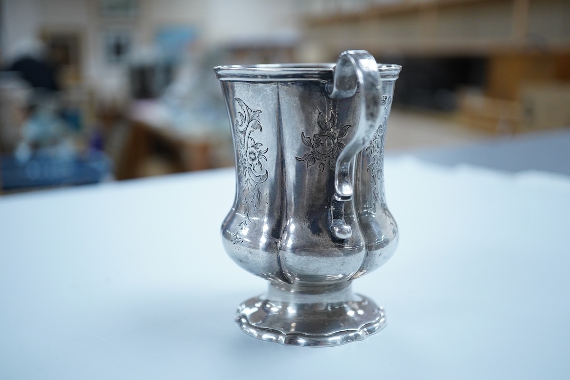 A Victorian engraved silver christening mug, on a pedestal foot, by Daniel & Charles Houle, London, 1848, 97mm, 4.4oz.